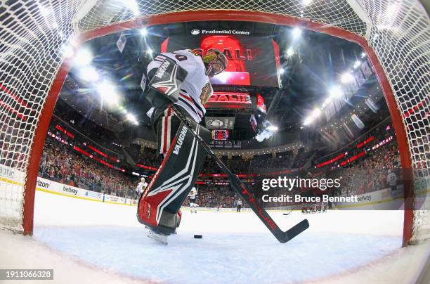 The New Jersey Devils celebrate the game winning goal by Michael McLeod against Arvid Soderblom of the Chicago Blackhawks at Prudential Center on...