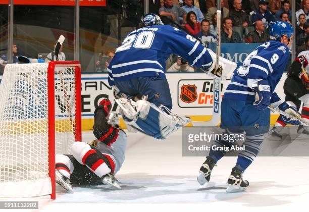 Ed Belfour and Calle Johansson of the Toronto Maple Leafs skate against the Ottawa Senators during NHL playoff game action on April 8, 2004 at Air...