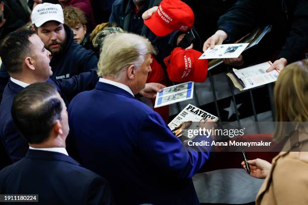 Republican presidential candidate, former U.S. President Donald Trump signs autographs for guests after speaking at a campaign rally on January 05,...