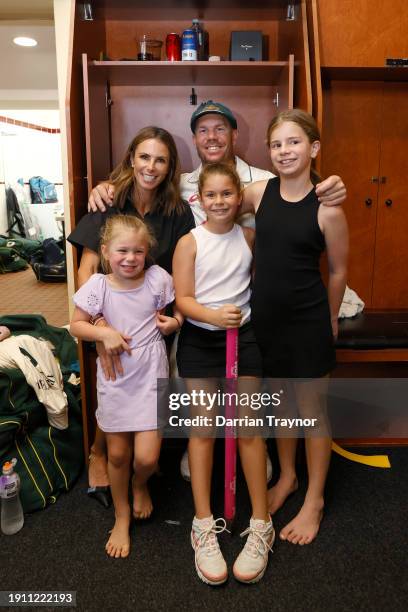 David Warner of Australia poses for a photo at his locker in the S.C.G. Change rooms with his wife Candice and children Ivy Mae, Indy Rae and Isla...