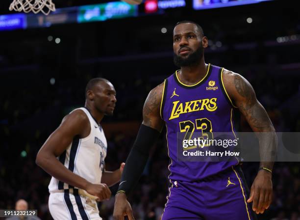 LeBron James of the Los Angeles Lakers reacts after his dunk in front of Bismack Biyombo of the Memphis Grizzlies during the first half at Crypto.com...