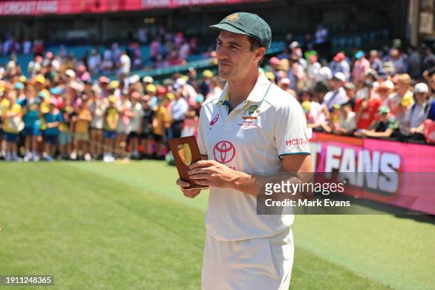 Pat Cummins of Australia poses with his player of the series trophy during day four of the Men's Third Test Match in the series between Australia and...