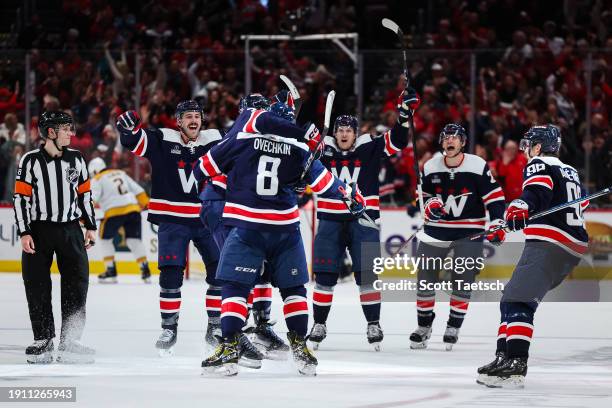 Alex Ovechkin of the Washington Capitals celebrates with John Carlson, and Joel Edmundson after scoring a goal against the Nashville Predators during...