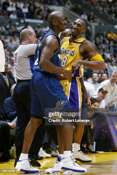 Kobe Bryant of the Los Angeles Lakers shares a laugh with Michael Jordan of the Washington Wizards during the game at Staples Center on March 28,...