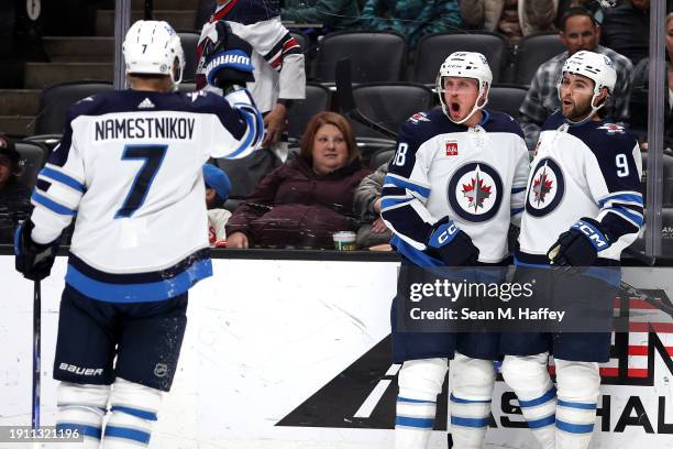 Vladislav Namestnikov and Alex Iafallo congratulate Nate Schmidt of the Winnipeg Jets during the third period of a game against the Anaheim Ducks at...