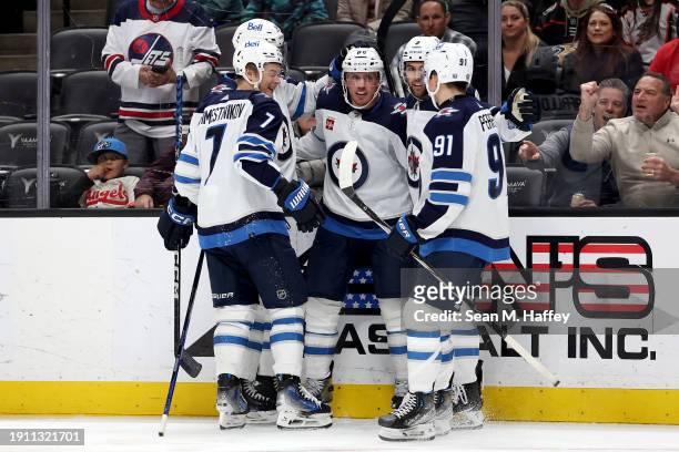 Vladislav Namestnikov and Alex Iafallo congratulate Nate Schmidt of the Winnipeg Jets during the third period of a game against the Anaheim Ducks at...
