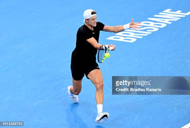 Holger Rune of Denmark plays a forehand in his semi final match against Roman Safiullin of Russia during day seven of the 2024 Brisbane International...