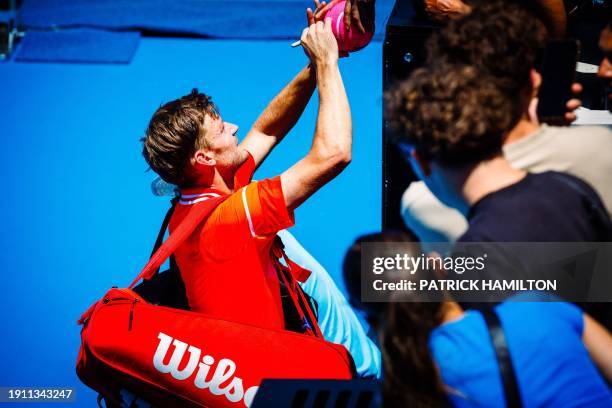 David Goffin signs autographes after a men's qualifying singles first round game between Belgian Goffin and Italian Travaglia, at the 'Australian...