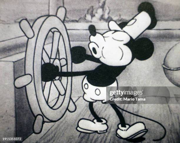 In this photo illustration, a still from Disney's 'Steamboat Willie' that was the debut of Mickey Mouse is seen in a book on January 05, 2024 in Los...