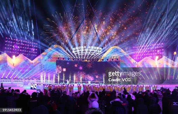 Tourists watch fireworks during the opening ceremony of the 40th Harbin International Ice and Snow Festival at the Harbin Ice and Snow World on...
