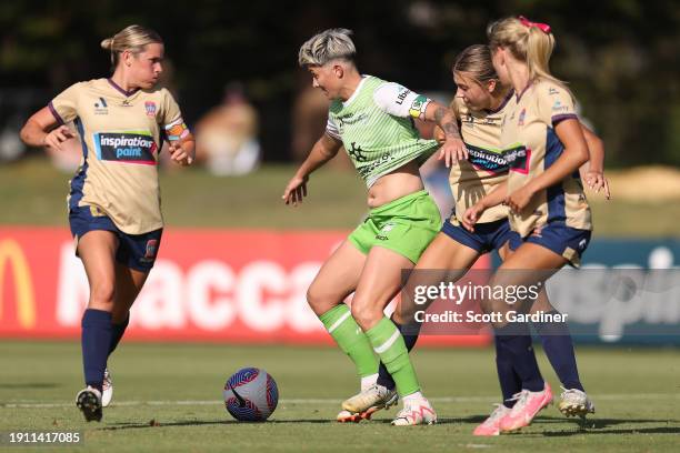 Michelle Heyman of Canberra United competes for the ball with Claudia Cicco of the Jets during the A-League Women round 11 match between Newcastle...