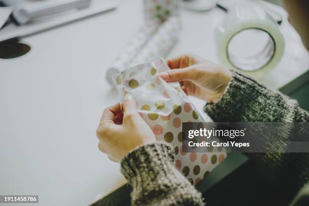 closeup image woman wrapping gifts - jan 19 stock pictures, royalty-free photos & images