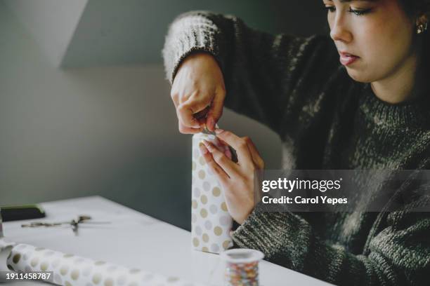 closeup image woman wrapping gifts - jan 19 stock pictures, royalty-free photos & images