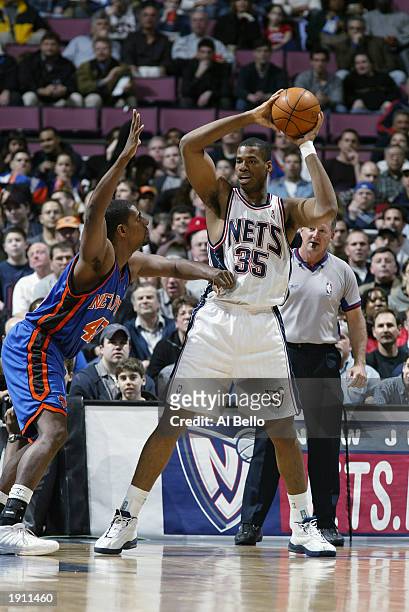 Jason Collins of the New Jersey Nets looks to pass against Kurt Thomas of the New York Knicks during the NBA game at Continental Airlines Arena on...