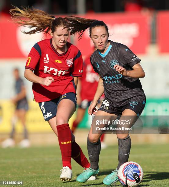 Laura Hughes of Melbourne City FC and Hannah Blake of Adelaide United during the A-League Women round 11 match between Adelaide United and Melbourne...