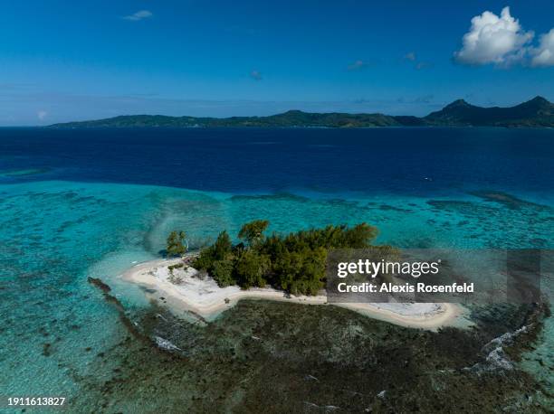View of a motu in the lagoon of Mangareva island on January 21 in the Gambier archipelago, Pacific Ocean. A motu is an islet of coral sand, usually...