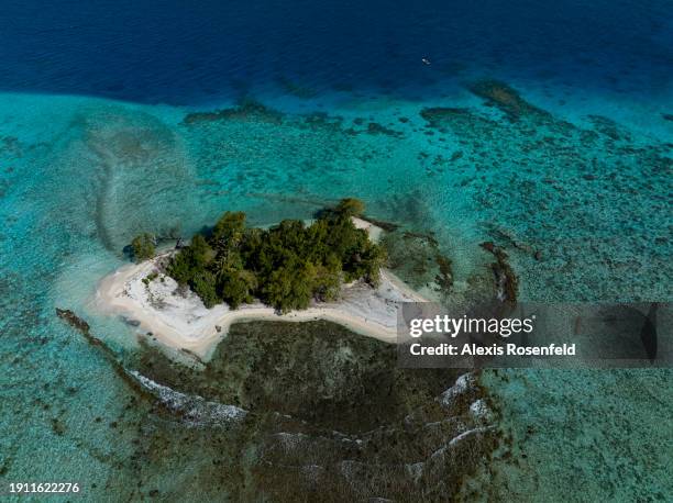 View of a motu in the lagoon of Mangareva island on January 21 in the Gambier archipelago, Pacific Ocean. A motu is an islet of coral sand, usually...