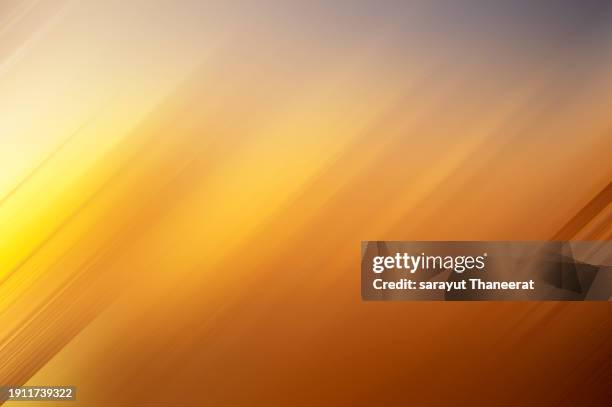background motion blur orange yellow warm colors summer - fokus-auf-den-hintergrund stock-fotos und bilder