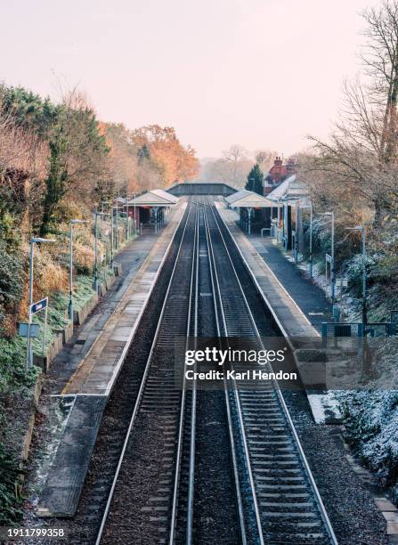 an empty train station on a cold morning in surrey - surrey stock pictures, royalty-free photos & images