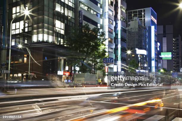 Light Trails On A Street With Illuminated Buildings At Nighttime. Tokyo, Japan.
