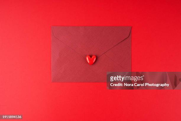 red envelope with heart shape seal - valentine's day concept - anniversary seal stock pictures, royalty-free photos & images