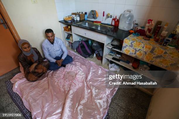 Palestinians Muhammad and Yasmine Abdel-Al from Gaza City got married in a school for displaced people in the city of Rafah in the southern Gaza...