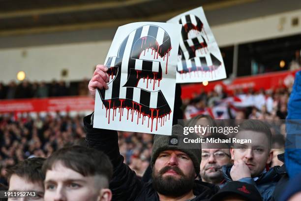 Sunderland fan holds a black and white banner with a £ sign on prior to the Emirates FA Cup Third Round match between Sunderland and Newcastle United...