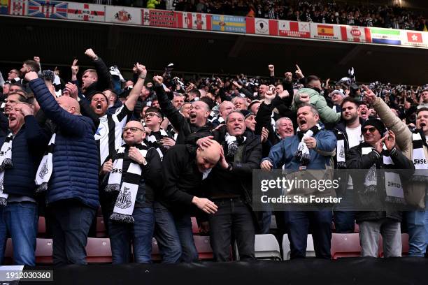 Fans of Newcastle United celebrate after Joelinton of Newcastle United scores his team's first goal during the Emirates FA Cup Third Round match...