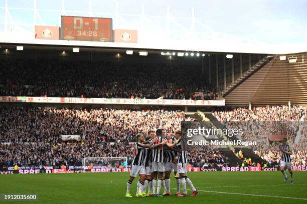 Joelinton of Newcastle United celebrates with teammates after scoring his team's first goal during the Emirates FA Cup Third Round match between...