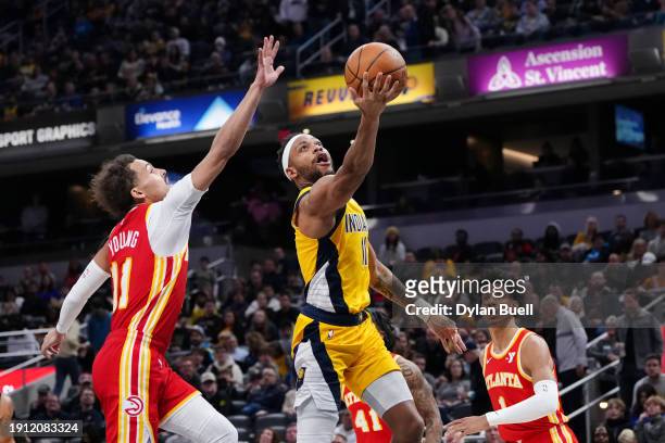 Bruce Brown of the Indiana Pacers attempts a shot while being guarded by Trae Young of the Atlanta Hawks in the third quarter at Gainbridge...