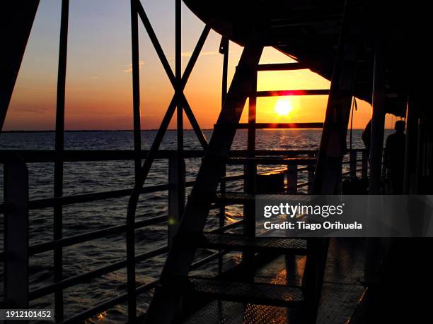 sunset, view from a boat sailing on the amazon river, brazil - molhado stock pictures, royalty-free photos & images