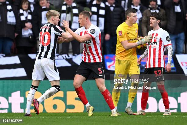 Anthony Gordon of Newcastle United clashes with Daniel Ballard of Sunderland during the Emirates FA Cup Third Round match between Sunderland and...