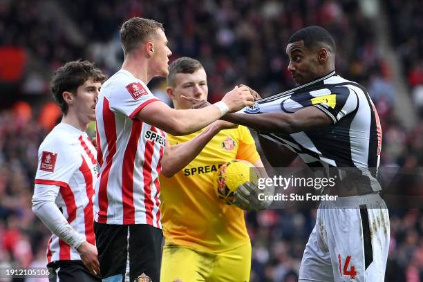 Daniel Ballard of Sunderland clashes with Alexander Isak of Newcastle United during the Emirates FA Cup Third Round match between Sunderland and...