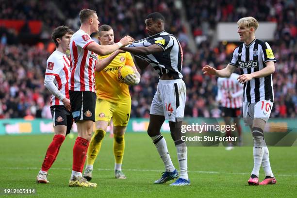 Daniel Ballard of Sunderland clashes with Alexander Isak of Newcastle United during the Emirates FA Cup Third Round match between Sunderland and...
