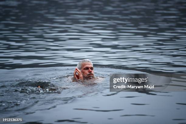 Participant swims in Schlachtensee Lake during the Ice Dipping Movement challenge on January 06, 2024 in Berlin, Germany.