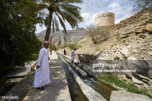 Man In Traditional Dress At Falaj Irrigation System In Birkit Al Mawz Village,jabal Akhdar.