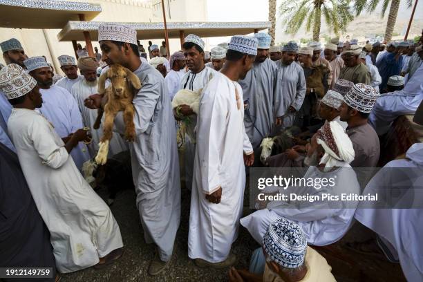 Traditionally Dressed Men Bidding At The Friday Goat Souk.