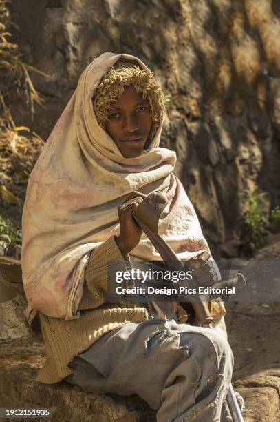 Beggar Sitting On A Rock. Ethiopia.