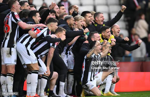 The Newcastle squad pose for a celebration picture after the Emirates FA Cup Third Round match between Sunderland and Newcastle United at Stadium of...