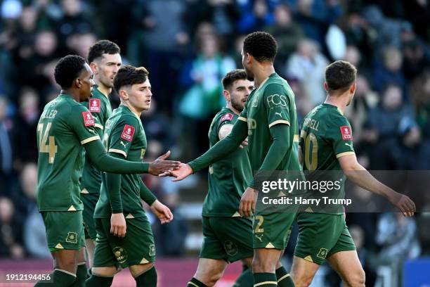 Luke Cundle of Plymouth Argyle celebrates scoring his team's first goal with teammates during the Emirates FA Cup Third Round match between Plymouth...