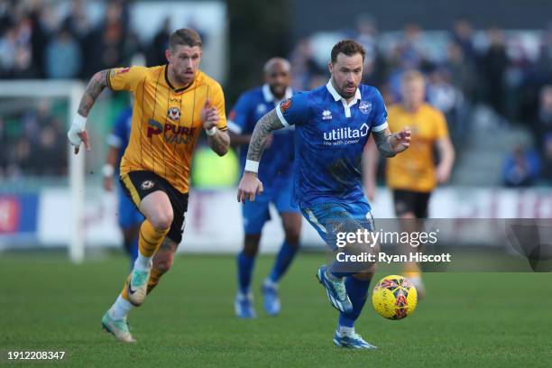 Chris Maguire of Eastleigh on the ball whilst under pressure from Scot Bennett of Newport County during the Emirates FA Cup Third Round match between...