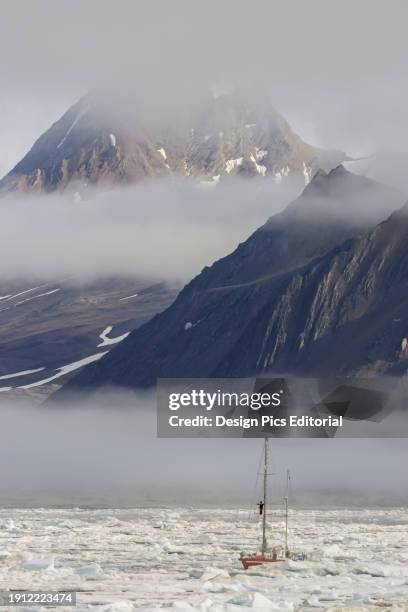 Sail boat navigates pack ice, Hornsund, Spitsbergen, Svalbard, Norway.