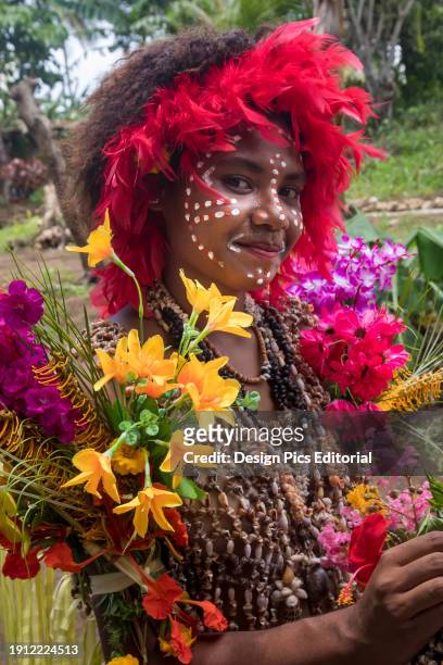 Village girl in tapa bark cloth dresses preparing to perform traditional sing sing Melanesian tribal dance in Natade Village in the Tufi Fjords of...