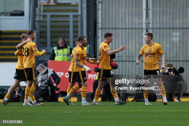 James Clarke of Newport County celebrates with teammates after scoring his team's first goal during the Emirates FA Cup Third Round match between...