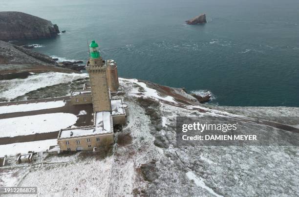 An aerial view the snow-covered Cap Frehel lighthouse in Plevenon, western France, on January 9, 2024.