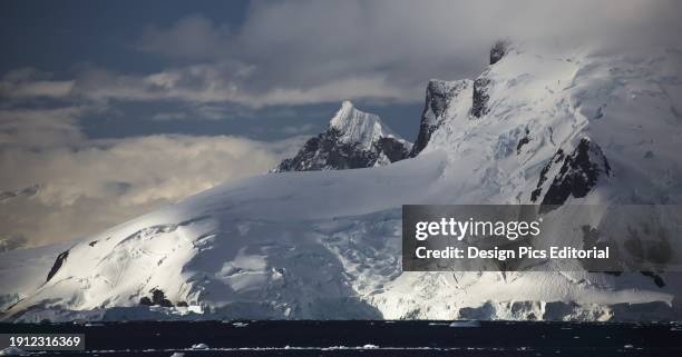 Setting Sun On Lemaire Island In Paradise Harbour, Antarctic Peninsula. Antarctica.