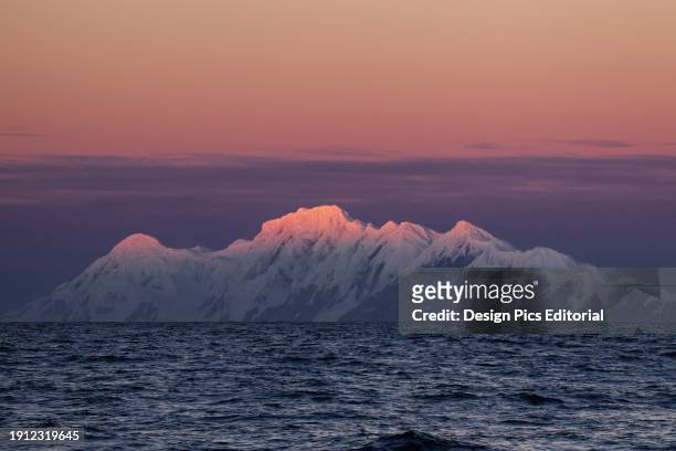 Smith Island With A Pink Sky And Glowing Mountain Peaks, Antarctic Peninsula. Antarctica.