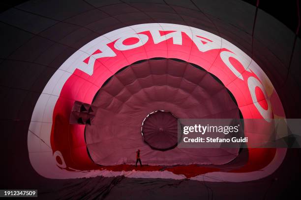 People inflating hot air balloons before flying during the 34th International Balloon Rally Of The Epiphany on January 6, 2024 in Mondovi, Italy. The...
