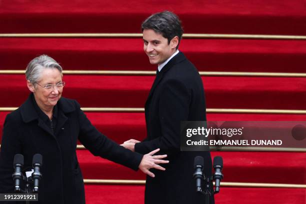 Newly appointed Prime minister Gabriel Attal greets outgoing Prime minister Elisabeth Borne at the end of the handover ceremony at the Hotel Matignon...