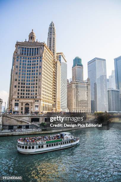 Chicago architecture lining the river with a tour boat. Chicago, Illinois, United States of America.